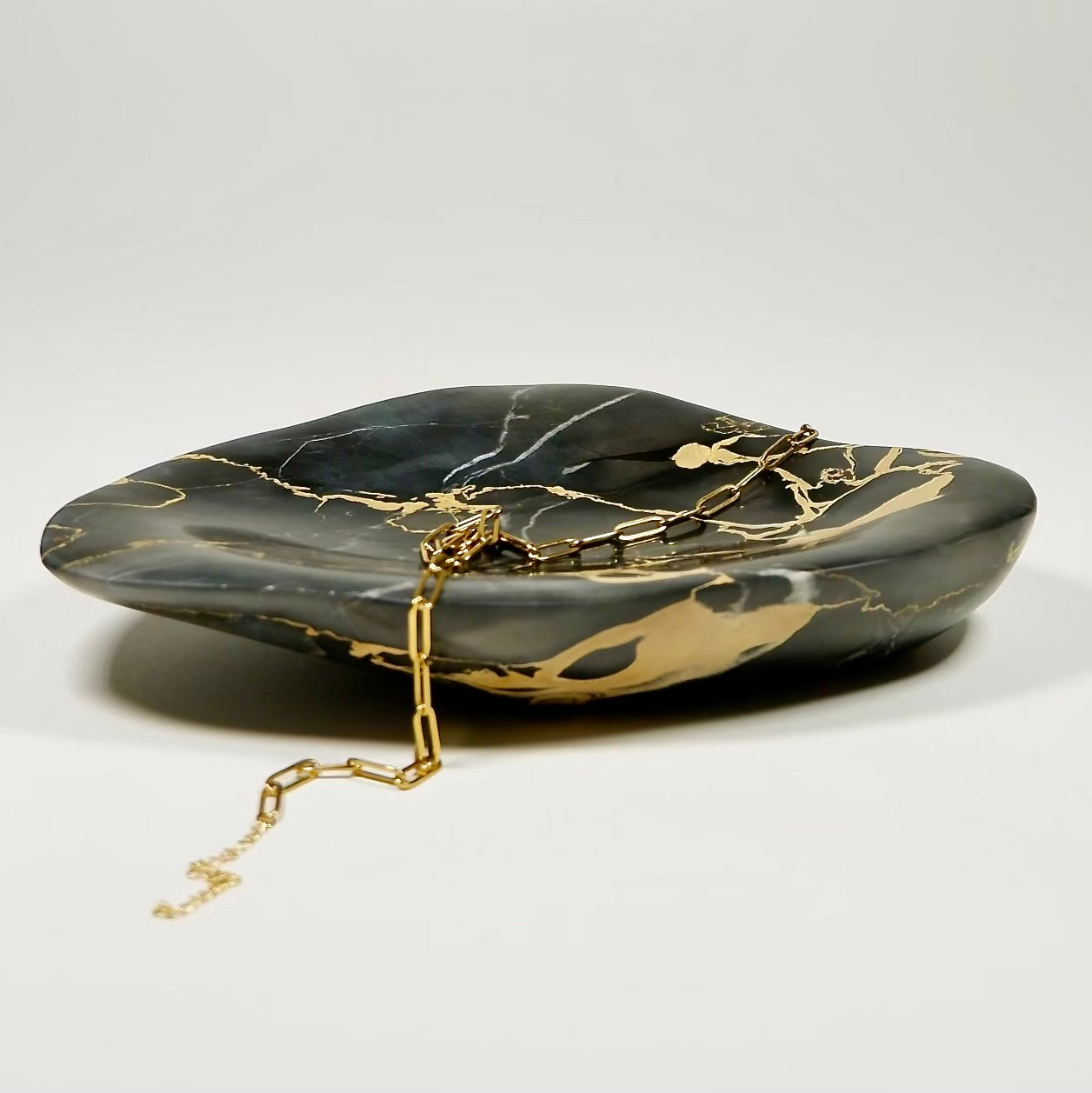 Fathom Stone Art bowl collection features unique hand carved shapes & wonderfully patterned stones from around the world.  This Italian black gold marble is exquisite.