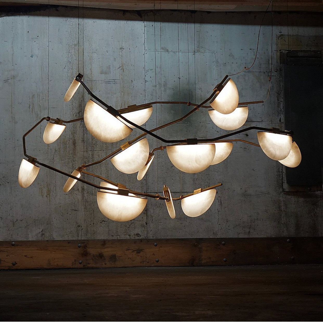Glowing stone lights are trending on instagram and these half moon lights are easy to love. Antiqued brass against the natural alabaster gives the designer room a glorious glow.