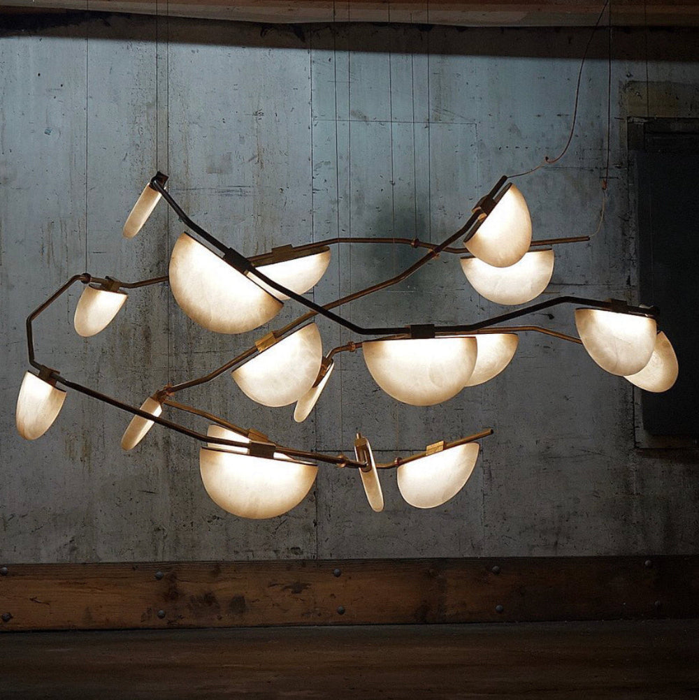 Glowing stone lights are trending on instagram and these half moon lights are easy to love. Antiqued brass against the natural alabaster gives the designer room a glorious glow.