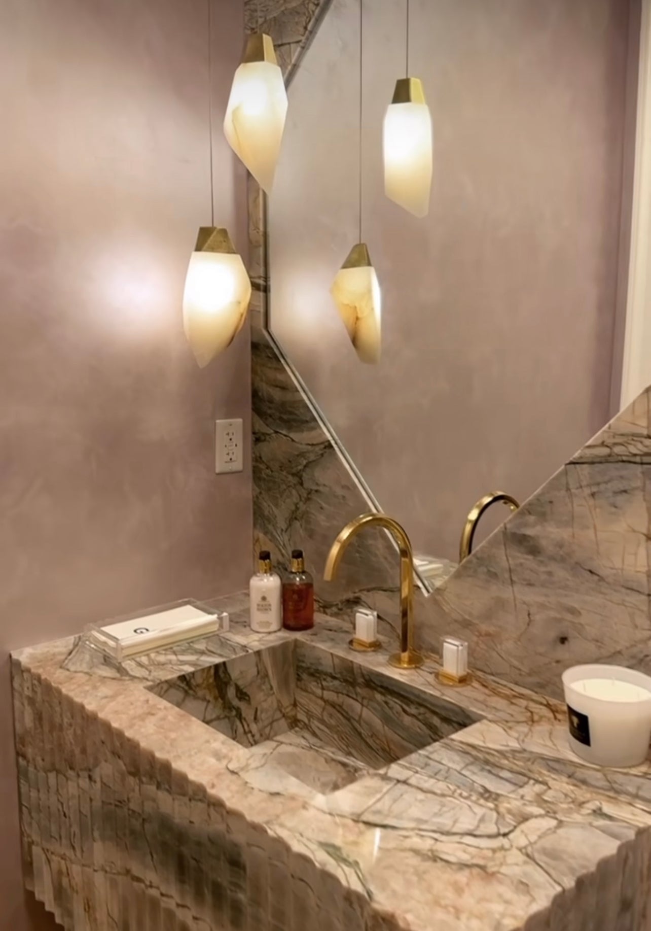 This Randy Zieber Alabaster natural stone with an antique brass set of two pendants looks perfect matching the facet shape on the onyx stone trim mirror.