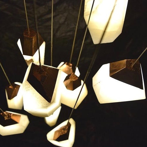 These alabaster pendants have thirty styles of tops giving each light a different shape. Randy Zieber light design at Fathom Stone Art.