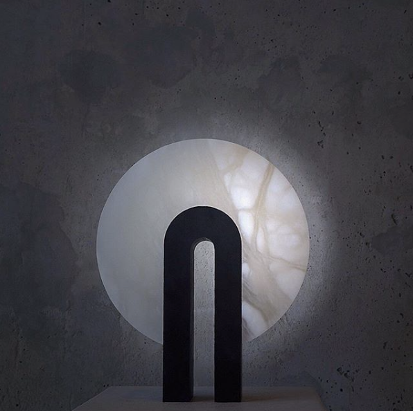 Alabaster stone full-moon lamp with basalt.  This round light glows wildly showing the natural alabaster veining.