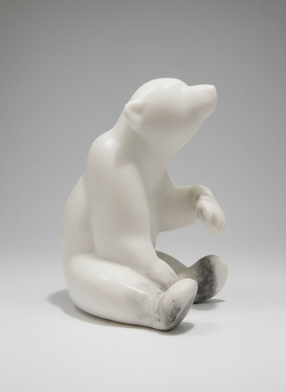 First Winter—a marble bear sculpture celebrating a cub's inaugural encounter with snow. Handcrafted in Whistler, BC from Italian white marble, this 8" x 6" x 9.5" piece weighs 18 pounds and captures the magic of that transformative moment. The luminous stone mirrors frost and ice, bringing the wonder and innocence of a young bear's first winter into your home.