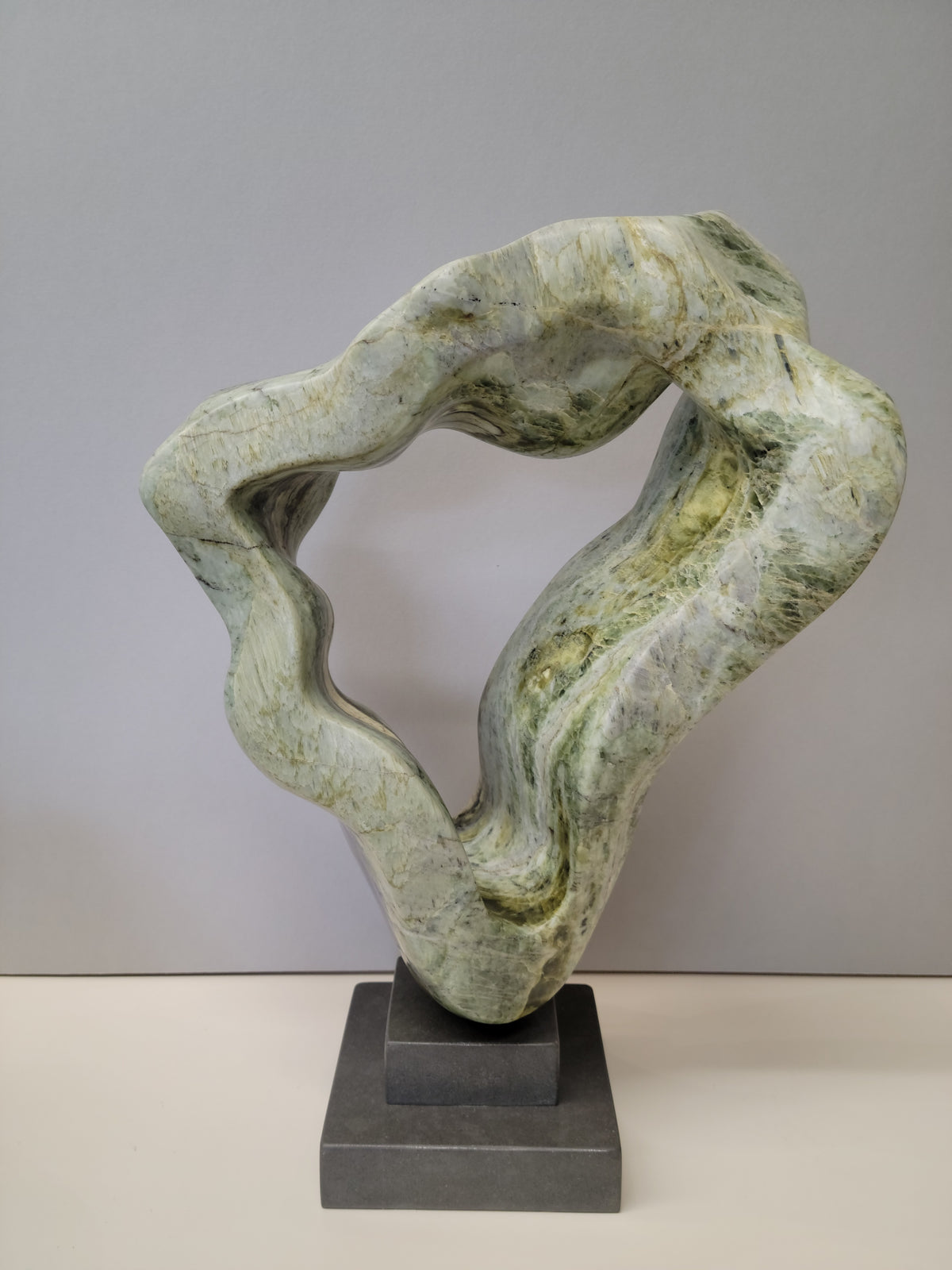Nature's Renewal – BC Firefly Brucite, Grey Granite Base stone sculpture