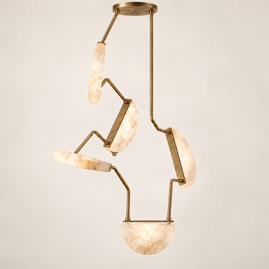 A modern multi-light pendant chandelier with brushed brass metal arms and curved, semi-opaque cream marble shades, suspended from a round brass ceiling canopy against a light beige background.