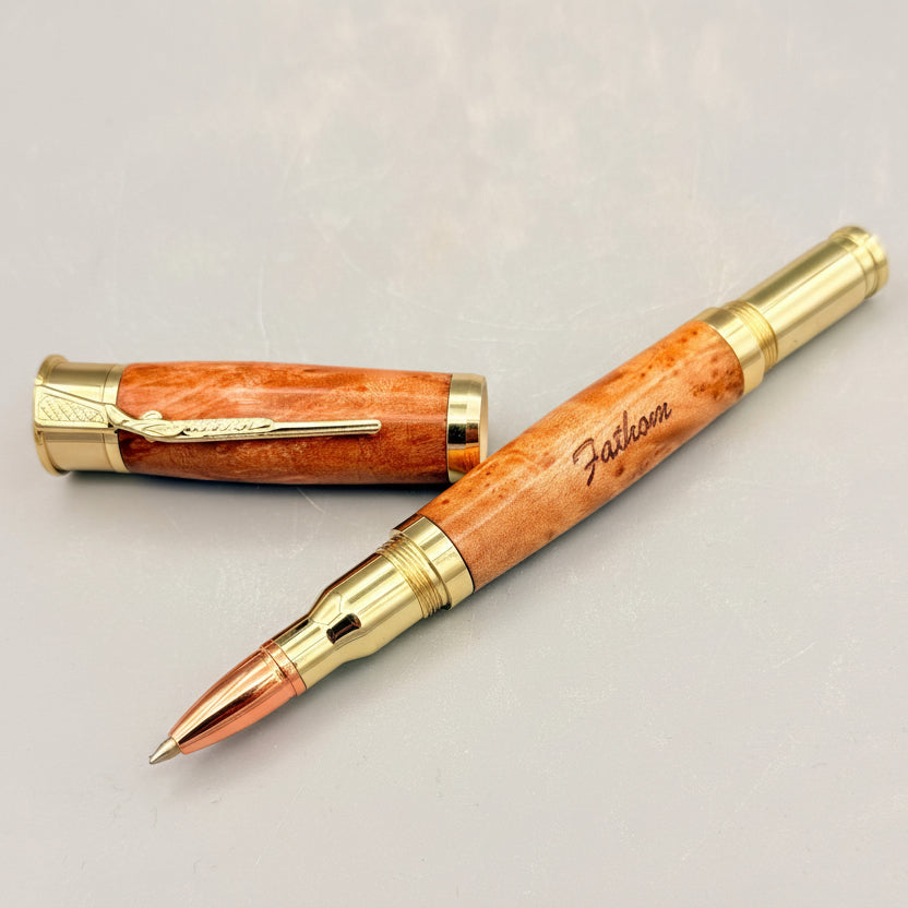 Wooden pen with gold accents on a light gray background