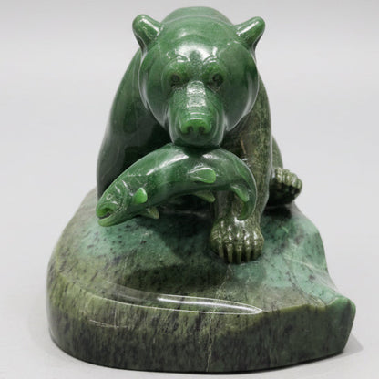 Hand-carved jade stone bear sculpture displayed in a Whistler art gallery.
