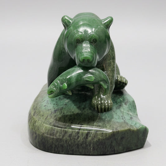 Hand-carved jade stone bear sculpture displayed in a Whistler art gallery.
