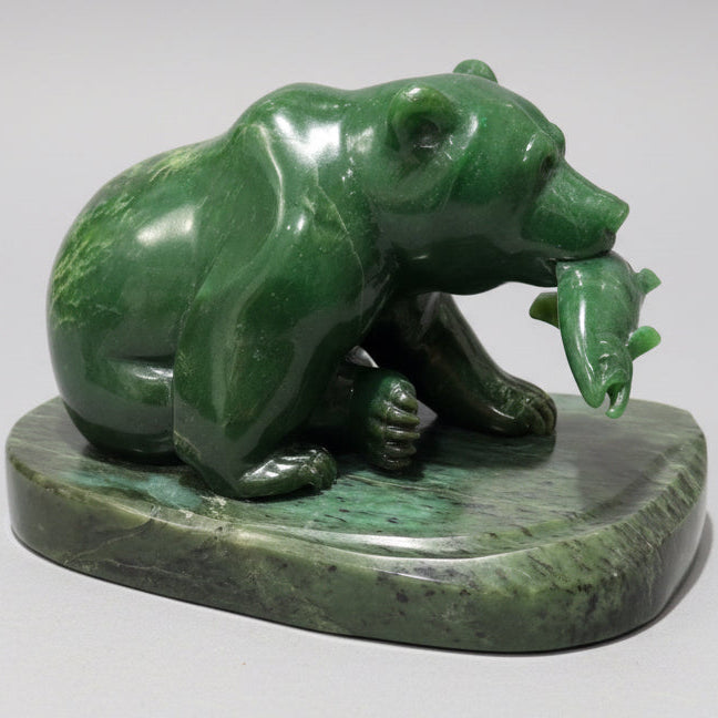 Green jade  stone sculpture of a bear holding a salmon