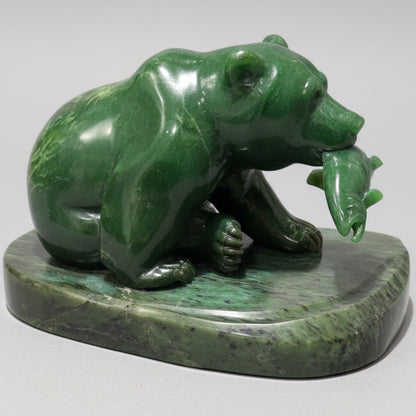 Green jade  stone sculpture of a bear holding a salmon