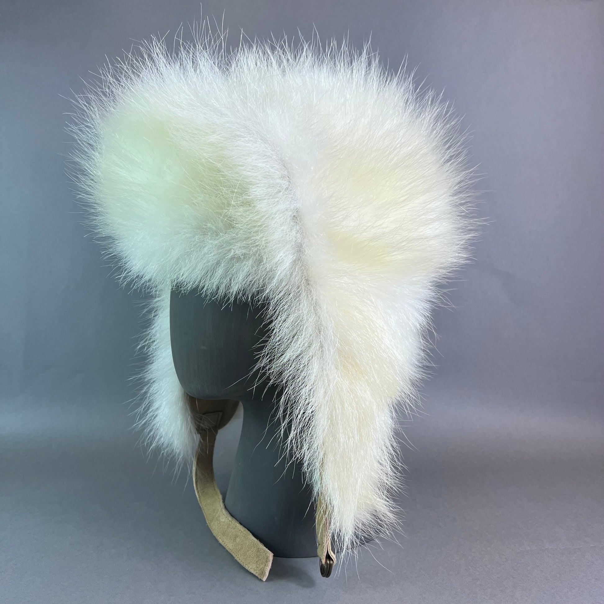 White fur hat with a gray background