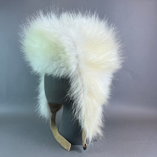 White fur hat with a gray background