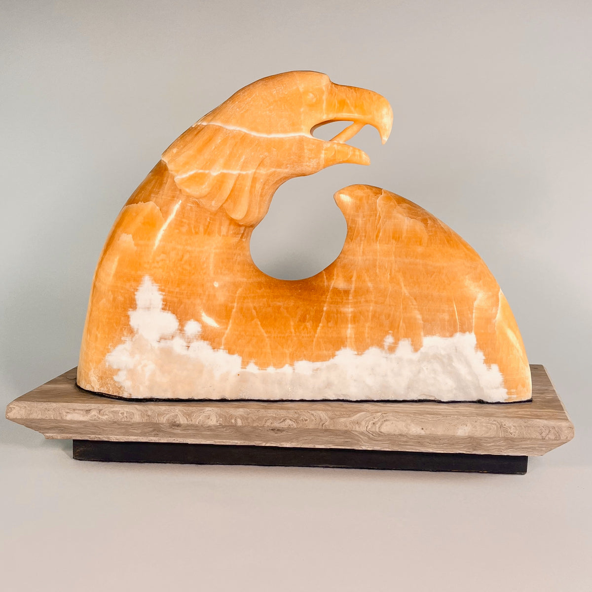 Seafoam Eagle – Golden Onyx, Limestone base stone sculpture