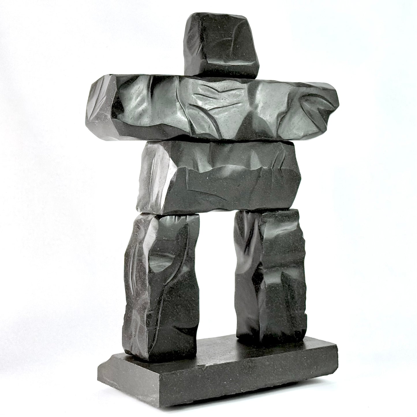 a hand carved gray basalt stone scupltiure replica of whistler BC's famous peak chair inukshuk
