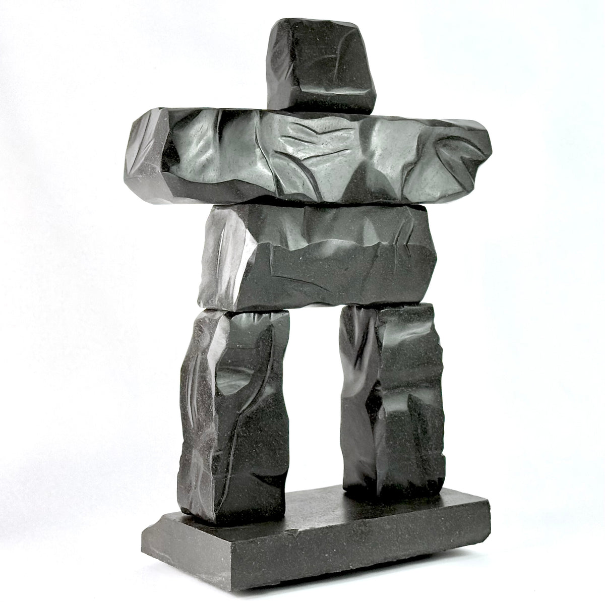a hand carved gray basalt stone scupltiure replica of whistler BC's famous peak chair inukshuk
