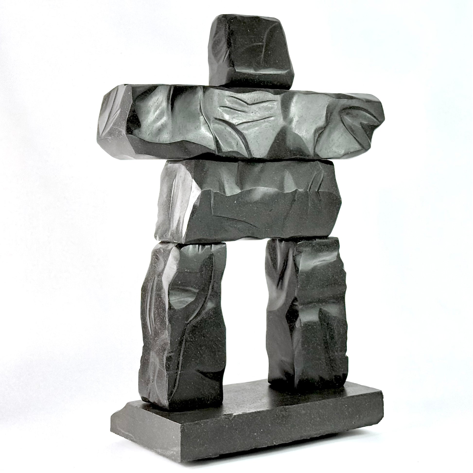 a hand carved gray basalt stone scupltiure replica of whistler BC's famous peak chair inukshuk
