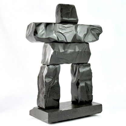a hand carved gray basalt stone scupltiure replica of whistler BC's famous peak chair inukshuk
