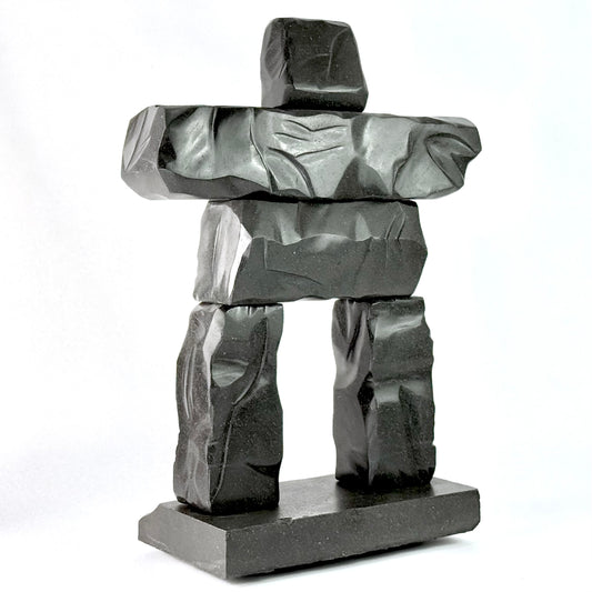 a hand carved gray basalt stone scupltiure replica of whistler BC's famous peak chair inukshuk
