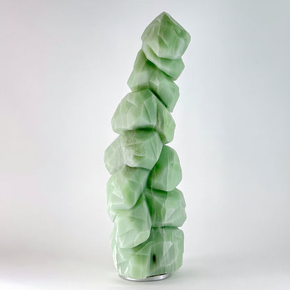 Discover the serene beauty of British Columbia's winter landscape captured in hand-carved stone. This striking Emerald Snow Tree sculpture showcases intricate detail work, with delicate snow-laden branches emerging from rich emerald tones. This piece is uniquely carved, making it a one-of-a-kind artistic treasure. Perfect for nature lovers and art collectors seeking authentic Canadian craftsmanship, this sculptural work brings the tranquility of snowy forests into your home or gallery space. A timeless