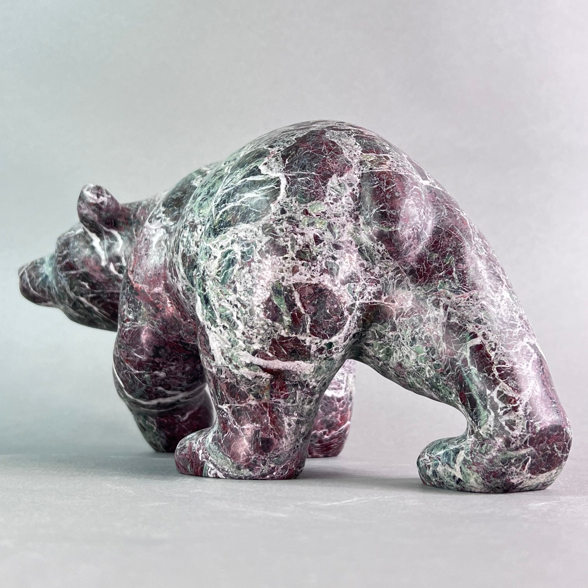 Marble bear sculpture on a light gray background