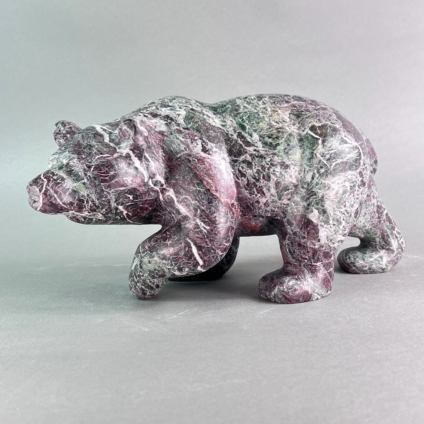 Luxury stone art sculpted bear walking carved out of a rare Italian marble fusion 