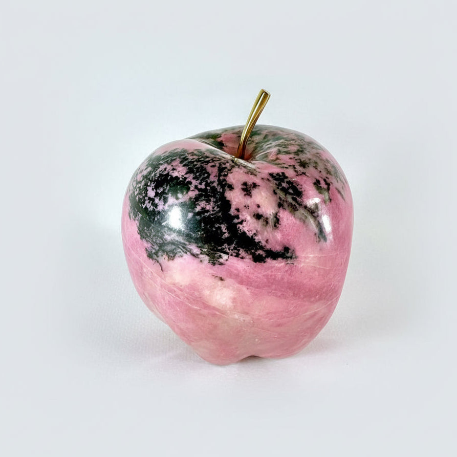 Discover the refined elegance of our Pink Apple—a masterpiece carved from premium British Columbia Pink Rhodonite. This exquisite sculpture showcases the stone's luminous pink depths and silky texture, making it a distinguished addition to any discerning collection. Each piece captures the natural beauty and timeless sophistication that only authentic Pink Rhodonite can deliver. A statement of taste and exclusivity for those who appreciate genuine artistry.