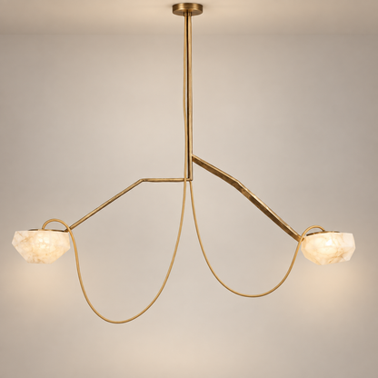 A modern alabaster two-light pendant chandelier with a brushed gold metal frame and faceted white stone shades, suspended against a neutral light gray background.