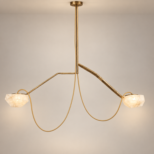 A modern alabaster two-light pendant chandelier with a brushed gold metal frame and faceted white stone shades, suspended against a neutral light gray background.
