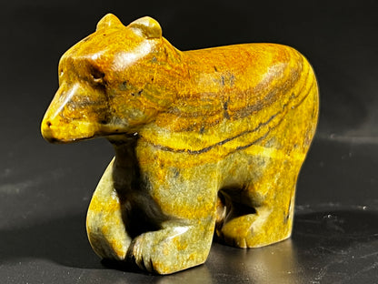 A Art Class Small Sculpture ~ 3+ Hours made of yellow stone on a black surface.
