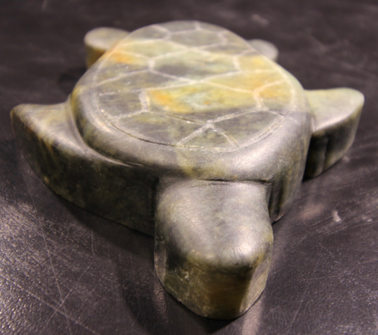A green and yellow Art Class Small Sculpture ~ 3+ Hours turtle on a black surface from FathomStoneArt.