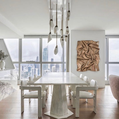 This Vancouver interior designer elegantly grouped this white alabaster with brass on a custom canopy hanging from a very modern designed space.