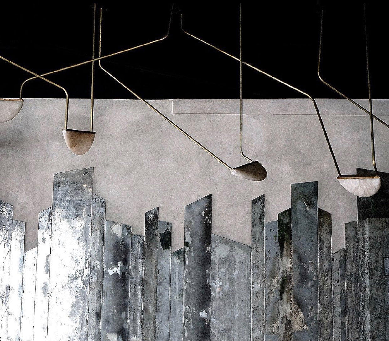 This restaurant space in Vancouver, BC is modern & artistic.  The alabaster pendants are hung at various angles looking as if they are suspended and frozen in the air.