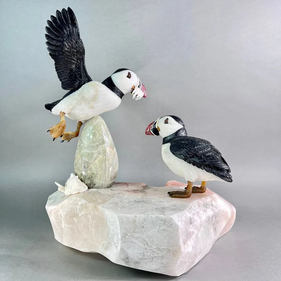 Puffins, a commissioned sculpture of two puffins on white stone
